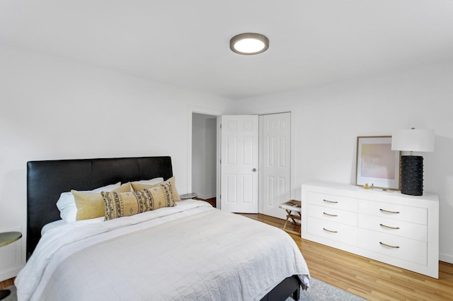 bedroom with a closet and light hardwood / wood-style flooring