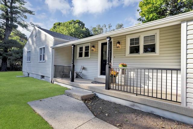 view of front of house with a front yard and a porch