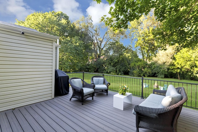 wooden deck with area for grilling, a yard, and outdoor lounge area