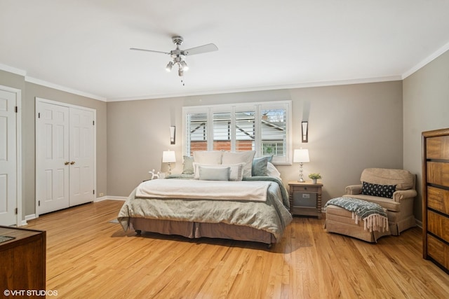 bedroom featuring light wood-style floors, baseboards, and ornamental molding