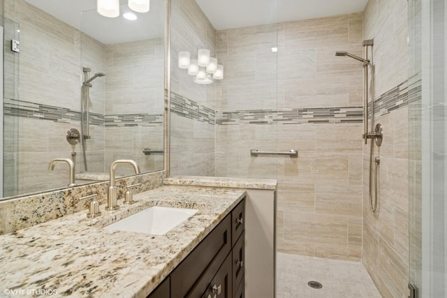 bathroom featuring a shower stall and vanity