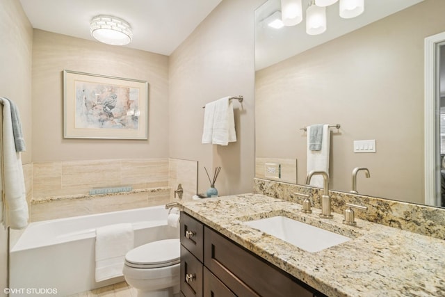 bathroom featuring toilet, a garden tub, and vanity