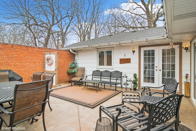 view of patio / terrace with french doors, area for grilling, and an outdoor living space