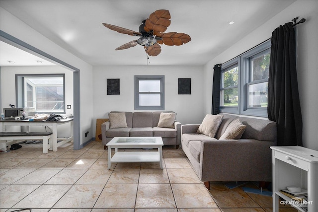 living room featuring ceiling fan and light tile patterned floors