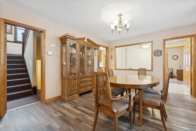 dining area featuring dark hardwood / wood-style flooring and a notable chandelier