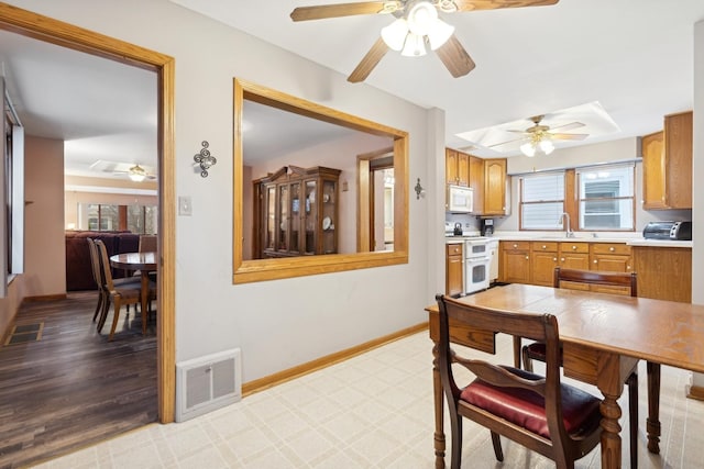 dining room featuring sink and ceiling fan