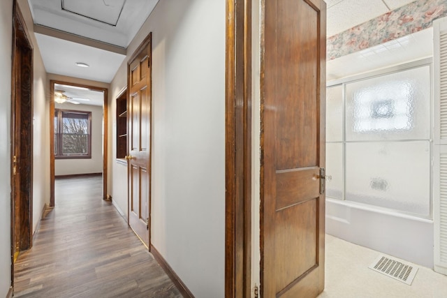 corridor with hardwood / wood-style floors