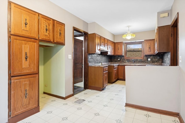 kitchen with backsplash and decorative light fixtures