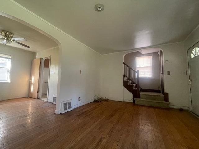 unfurnished living room with hardwood / wood-style flooring and ceiling fan