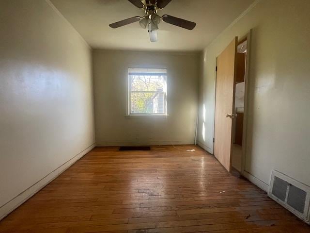 unfurnished room with hardwood / wood-style floors and ceiling fan