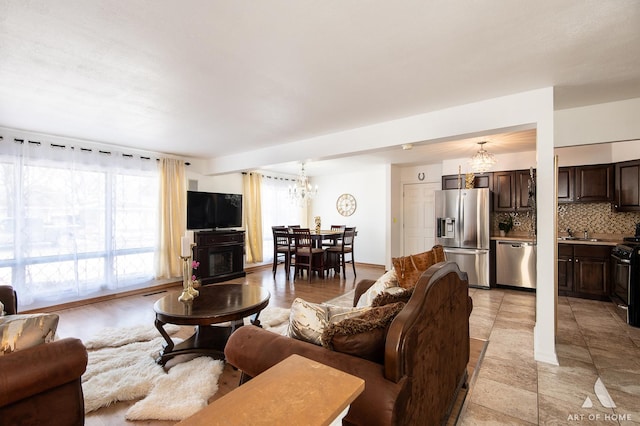 living room with sink and a notable chandelier