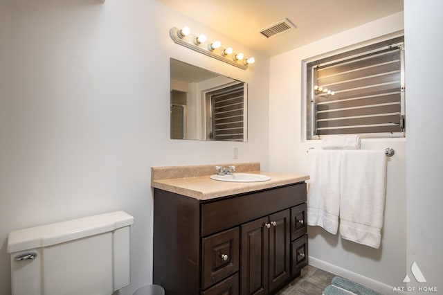 bathroom featuring vanity and toilet