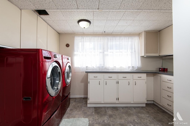 washroom featuring cabinets and washer and dryer