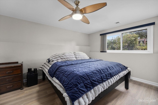 bedroom with hardwood / wood-style floors and ceiling fan