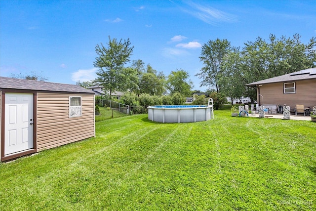 view of yard with a patio and an outbuilding