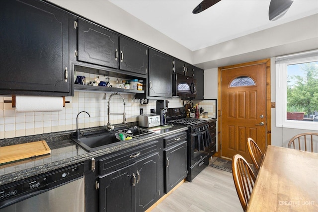 kitchen with sink, black appliances, light wood-type flooring, ceiling fan, and backsplash