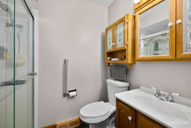 bathroom featuring vanity, an enclosed shower, and toilet