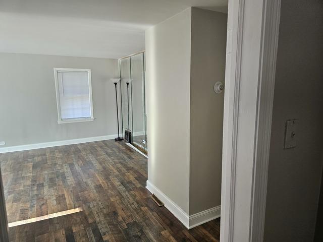 hall with dark hardwood / wood-style floors