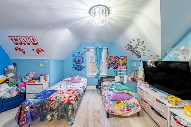 bedroom featuring lofted ceiling and light wood-type flooring