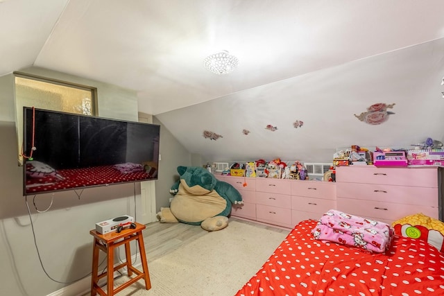 bedroom featuring hardwood / wood-style flooring and lofted ceiling