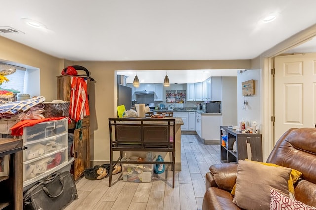 interior space with sink and white cabinets