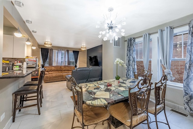 tiled dining area with a notable chandelier