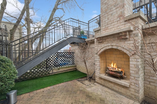 view of patio with an outdoor fireplace