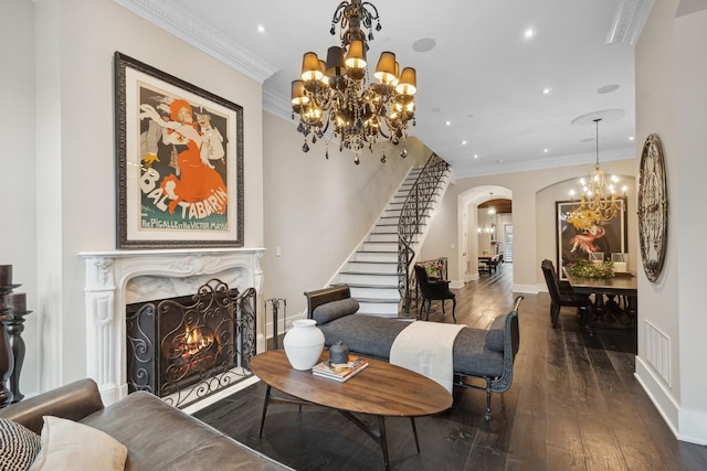 living room featuring crown molding, a high end fireplace, dark hardwood / wood-style flooring, and a chandelier