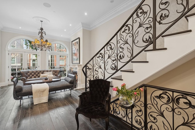 staircase with hardwood / wood-style flooring, ornamental molding, an inviting chandelier, and french doors