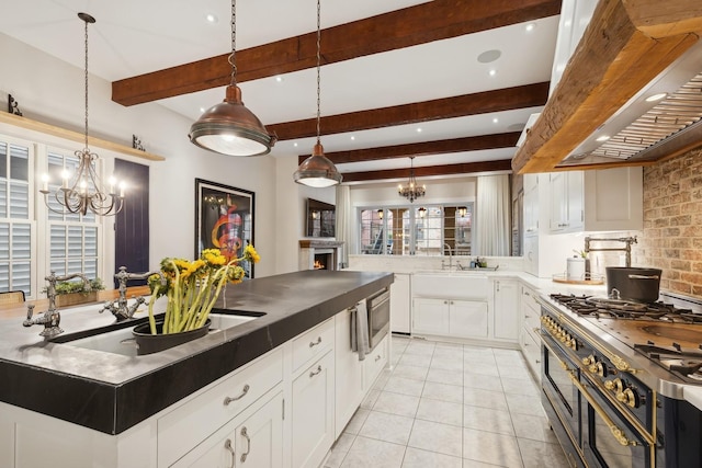 kitchen with pendant lighting, white cabinetry, backsplash, custom exhaust hood, and stainless steel appliances