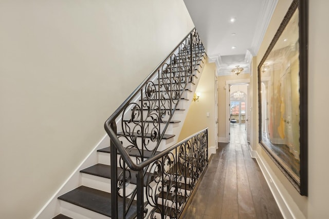 staircase featuring hardwood / wood-style flooring and ornamental molding