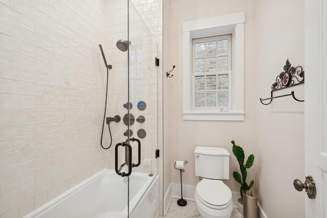 bathroom featuring tiled shower / bath and toilet