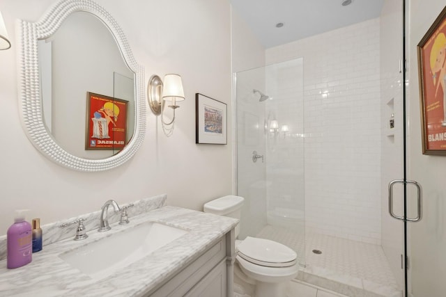 bathroom featuring vanity, toilet, and walk in shower