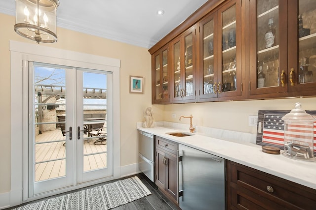 bar featuring french doors, sink, crown molding, dark hardwood / wood-style floors, and pendant lighting