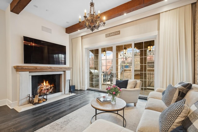 living room featuring beamed ceiling, dark wood-type flooring, and a notable chandelier