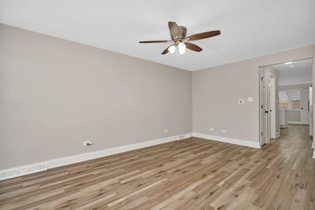 empty room featuring ceiling fan and light hardwood / wood-style floors