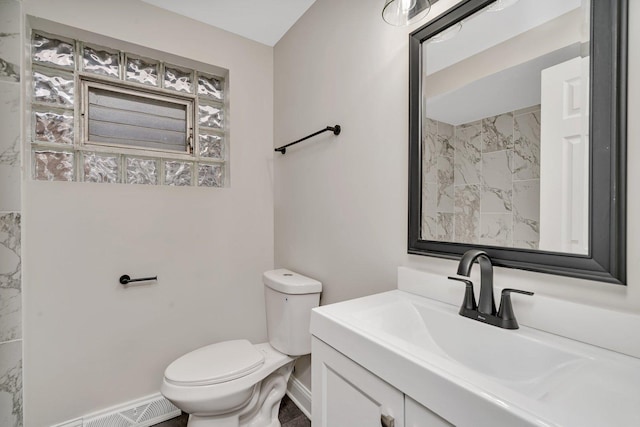 bathroom featuring vanity, toilet, and baseboard heating