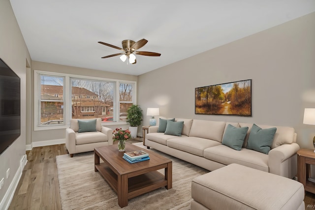 living room featuring ceiling fan and light wood-type flooring