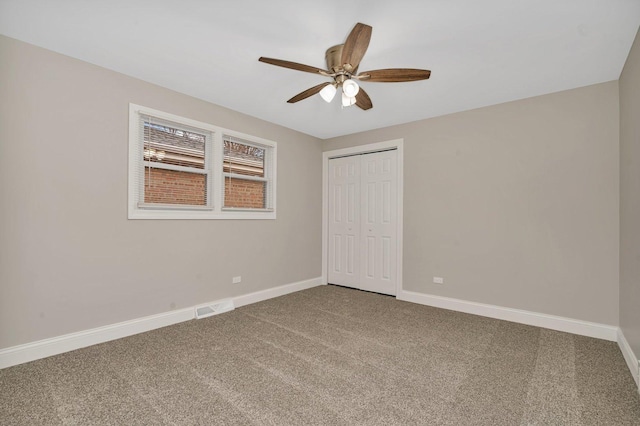 unfurnished bedroom featuring carpet, ceiling fan, and a closet