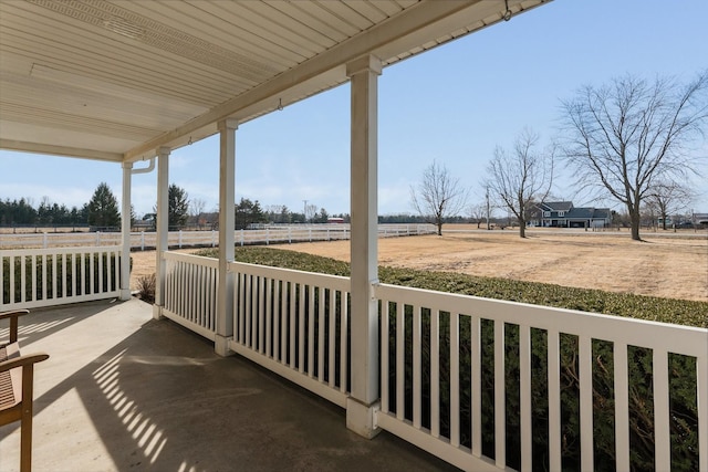 exterior space featuring a porch and a rural view