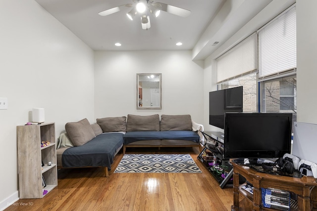 living room with ceiling fan and hardwood / wood-style floors