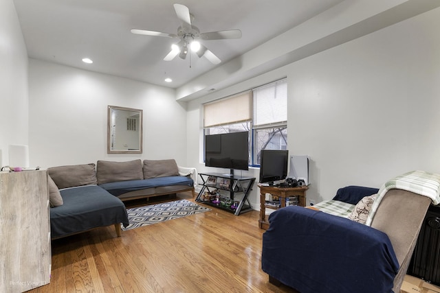 living room featuring wood-type flooring and ceiling fan