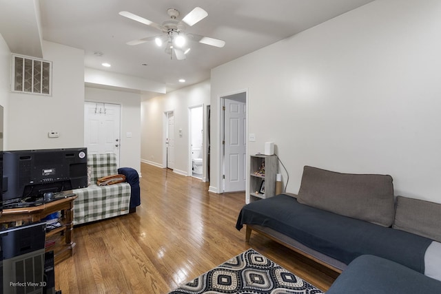 living room featuring hardwood / wood-style flooring and ceiling fan