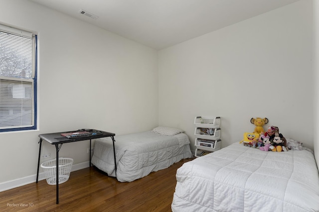 bedroom with dark hardwood / wood-style floors