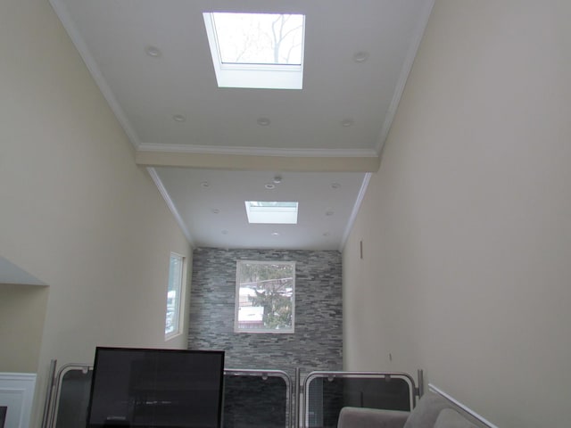 interior space with ornamental molding and a skylight