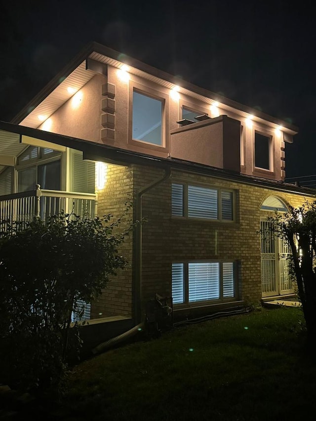 view of back house at twilight