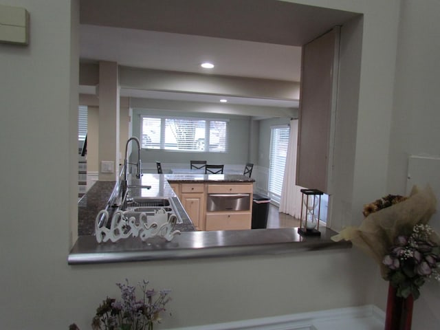 kitchen featuring sink, light brown cabinetry, and kitchen peninsula