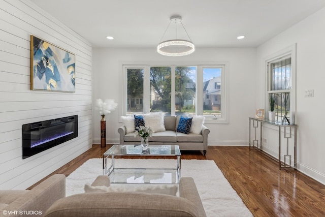 living room with a fireplace and dark hardwood / wood-style flooring