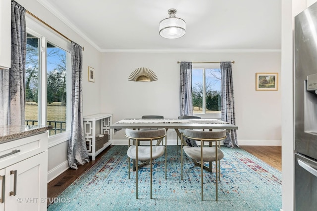 dining space with crown molding and dark hardwood / wood-style floors