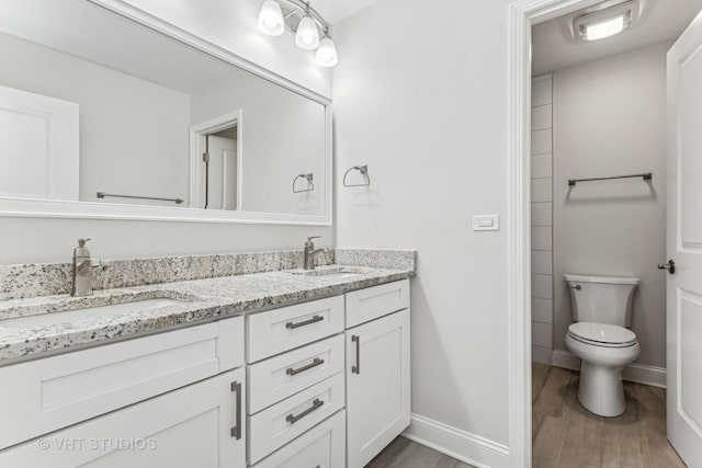 bathroom featuring hardwood / wood-style flooring, vanity, and toilet